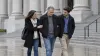 A man in everyday clothes walks with family supporters outside a federal courthouse in natural daylight, representing the uncertainty surrounding compassionate release.