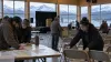 Campaign volunteers prepare a community event hall in Alaska with snow-covered mountains visible outside.
