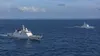 Illustrative view of two unmarked patrol vessels operating near a remote coral atoll.