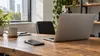 AI-generated illustrative image of an unbranded laptop and smartphone on a sunlit office desk; not a Salesforce or Braze location.