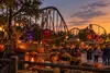 Autumn decorations and a roller coaster at a Texas amusement park