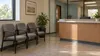AI-generated illustration of an empty, generic public-service office waiting area; not a photograph of a South Dakota government office or the officials named in this report.