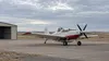 AI-generated editorial illustration of an unmarked single-engine firefighting aircraft on a rural prairie airfield; not the actual Wall base or a documented event.
