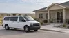 AI-generated illustration of an unmarked passenger van outside a small rural clinic; not an actual Kansas provider or grant-funded service.