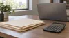 AI-generated illustration of blank folders and a calculator on an office desk; not actual Louisiana audit records or a government office.