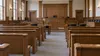 AI-generated illustration of an empty, generic New England courtroom; not an actual hearing or identifiable Maine courthouse.