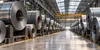 AI-generated illustrative steel-coil warehouse; not a photograph of a Nucor facility.