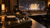 Unbranded vinyl record and mixing console in a recording studio overlooking a softly lit concert stage