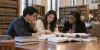 Law students study together in a university law library.