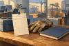 AI-generated conceptual illustration of a blank time card, work glove and notebook; not an actual Texas workplace, payroll record or data chart.