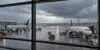 Illustrative editorial view of unbranded passenger aircraft at a rain-swept Texas airport during severe thunderstorms