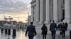 Illustrative view of attorneys approaching a federal courthouse near cargo terminals.