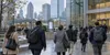Illustrative editorial view of American office workers walking through a business district on an overcast morning