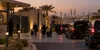 An illustrative dusk scene shows anonymous diplomatic staff and family travelers carrying luggage toward unmarked vehicles at a secure compound in Riyadh.