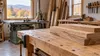 AI-generated editorial illustration of a generic small woodworking workshop with unmarked lumber and equipment; not an actual Vermont grant recipient or documented project.
