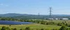 Illustrative Virginia energy landscape with transmission lines, a solar field and a distant data-center building