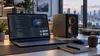 Isang premium na laptop at compact na AI workstation sa isang propesyonal na mesa, na kumakatawan sa lokal na artificial-intelligence computing.