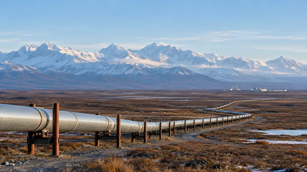 Illustrative natural-gas pipeline crossing Alaska tundra toward distant mountains.