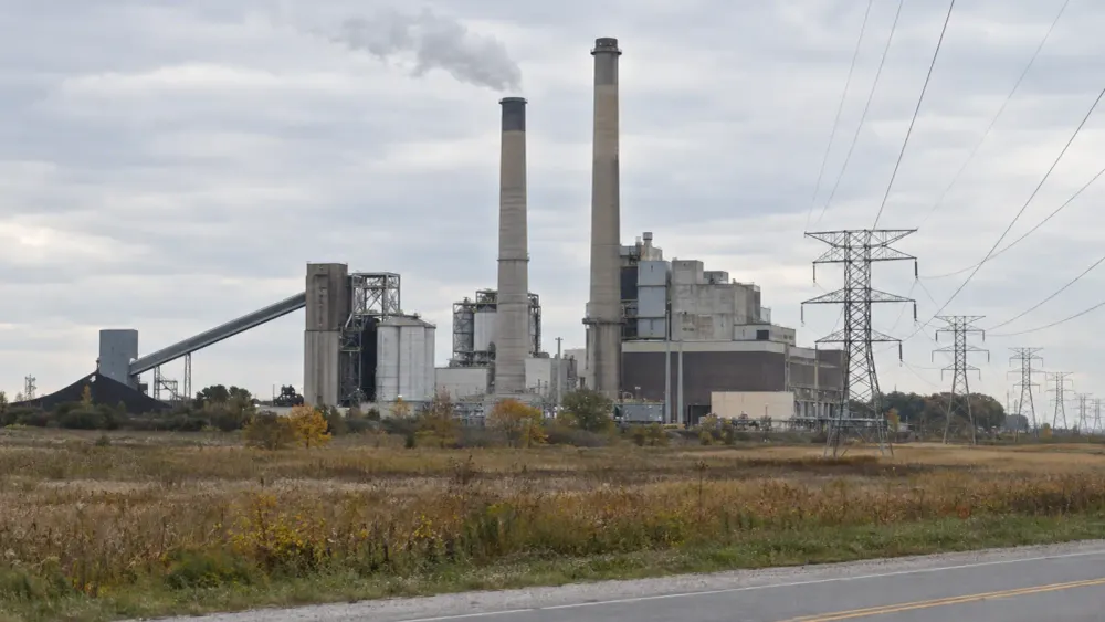 Unbranded coal-fired power station and transmission lines under natural overcast daylight in Michigan