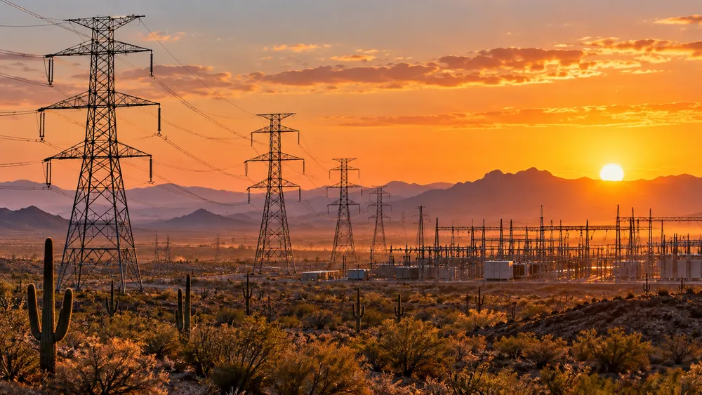 Illustrative view of high-voltage power infrastructure crossing Arizona’s desert landscape.