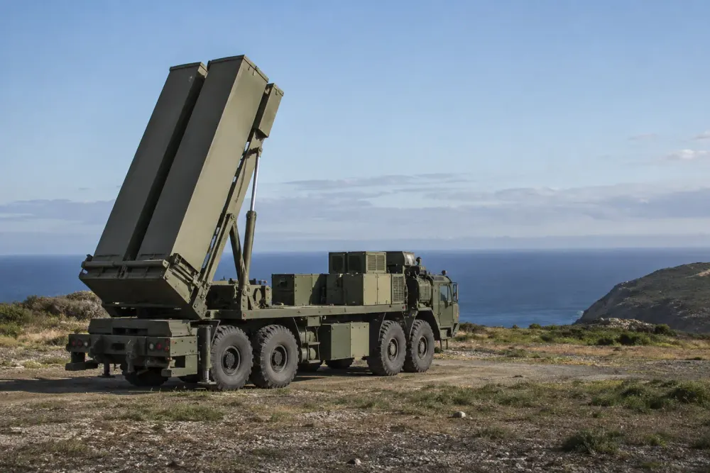 Unbranded mobile missile launcher positioned at a coastal military test range in daylight