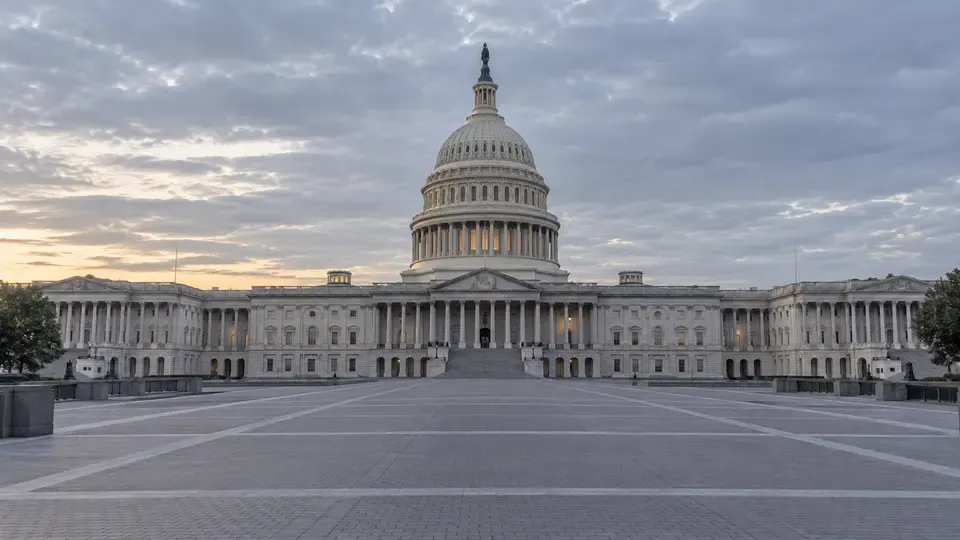 The U.S. Capitol viewed from an empty plaza under soft morning light.