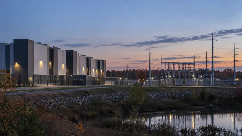 Generic data center and electrical substation at dusk in a New England industrial setting