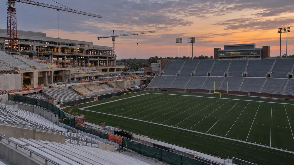 Conceptual view of a college football stadium undergoing a partial renovation at twilight