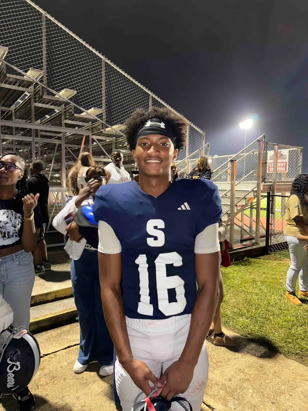 Nolan Xavier Wells smiling in his football uniform after a game