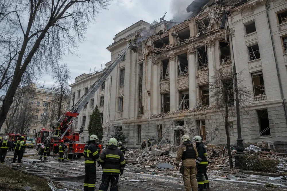 Emergency responders outside a damaged neoclassical building in Kyiv after a drone strike