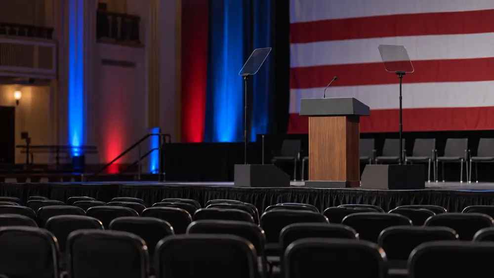 Empty American political campaign stage with lectern and teleprompters