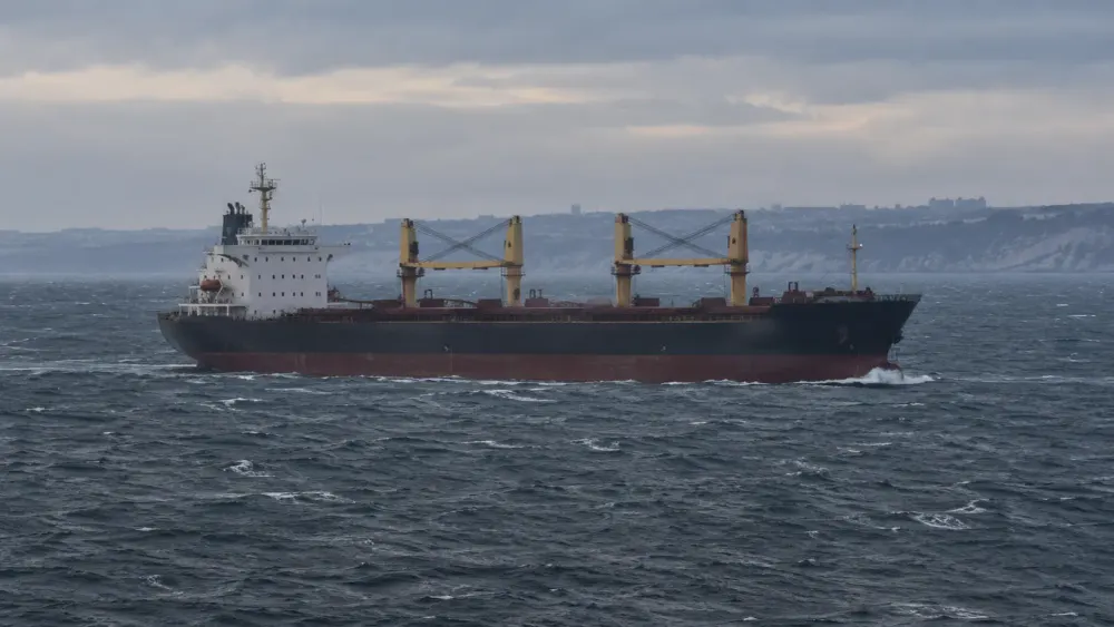 AI-generated editorial image of a civilian cargo ship sailing in rough Black Sea waters near a distant coastline