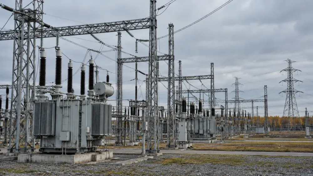 AI-generated illustrative electrical substation beneath an overcast autumn sky; not a photograph of an attacked facility.