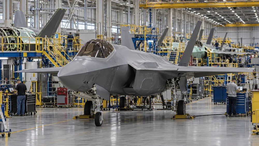 AI-generated editorial view of unbranded stealth fighter aircraft on a modern production line.