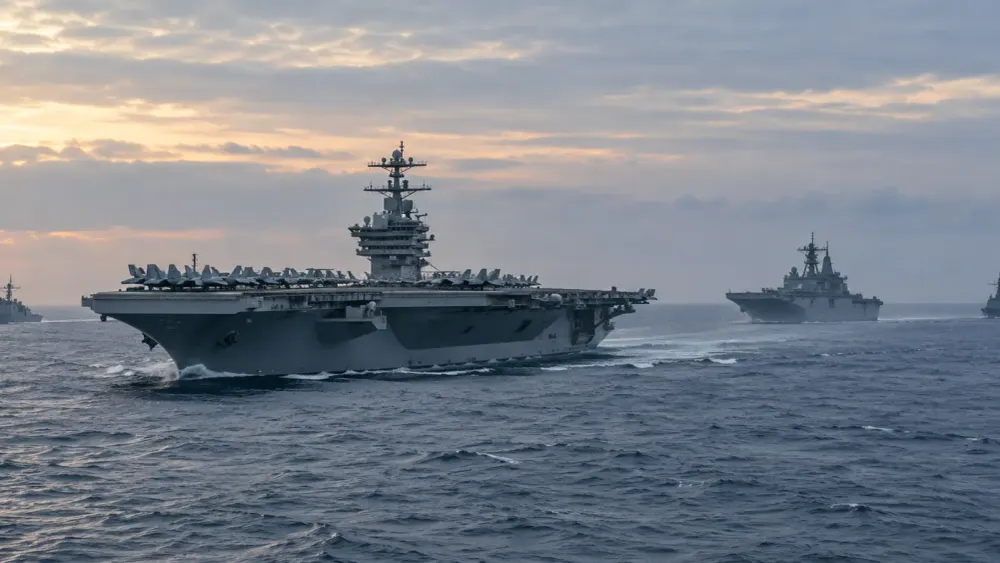 Illustrative view of a modern aircraft carrier and escort ships underway at dawn