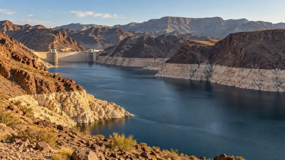 Illustrative wide view of low water at a desert reservoir in the Lake Mead region.