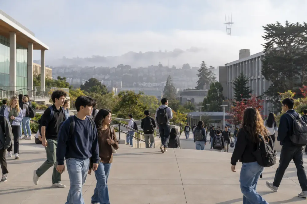 Students walk through a foggy urban public university campus in San Francisco.