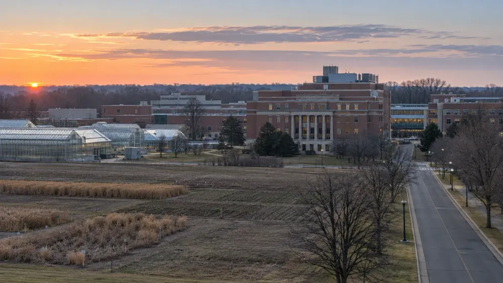 A federal agricultural research campus with laboratories, greenhouses and research fields at dawn.