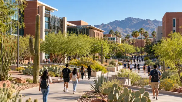 Students walking through a desert-landscaped public university campus in Arizona beneath clear morning skies.