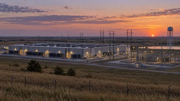 Large data center, electric substation and water tower on the Kansas prairie at sunset