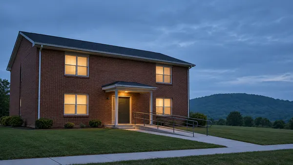 Illustrative view of a modest supportive-housing apartment building in Kentucky at dusk.