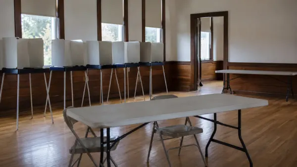 Empty voting booths in a New England municipal hall after polls closed