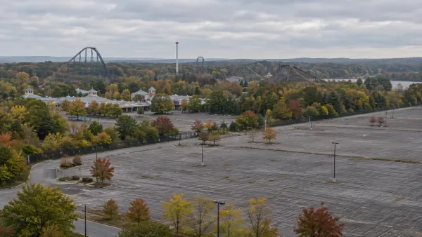 Illustrative aerial view of a closed amusement park and empty parking area in early autumn