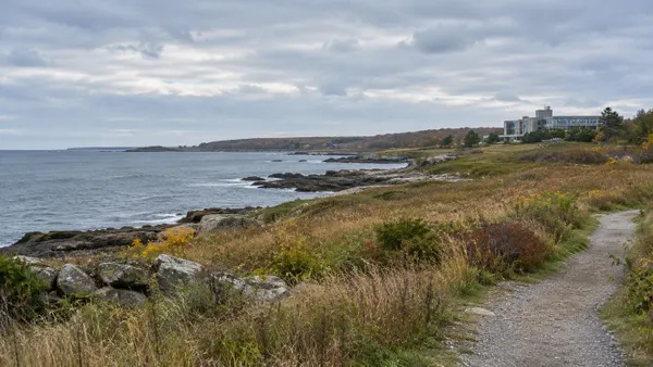 Conceptual Massachusetts coastline with an undeveloped meadow, public path and distant research building.
