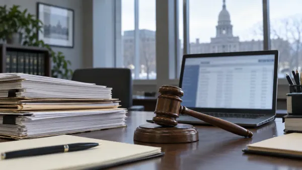 Conceptual government records desk with legal files, a gavel and a blurred database screen