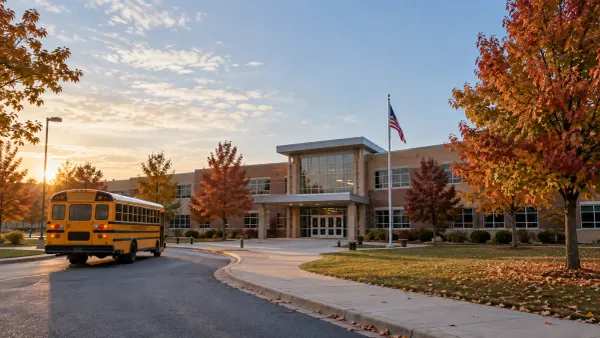 A generic Missouri public school building and school bus in early morning light