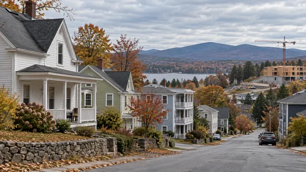 A New England residential street with a mix of homes in early autumn