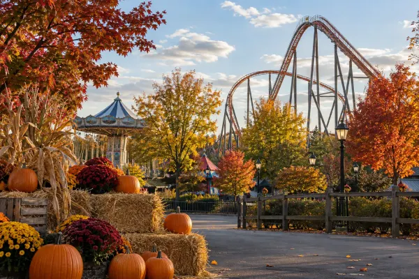 A generic amusement park decorated with pumpkins, hay bales and autumn foliage