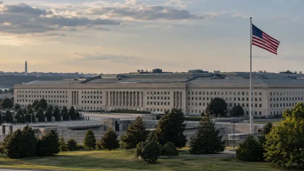 The Pentagon and a U.S. flag under subdued late-afternoon light.