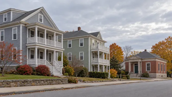 Illustrative quiet Rhode Island residential block with modest multi-family homes and a municipal building
